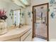 Bathroom vanity sink featuring a cabinet with a mirror and paintings at 5286 Hamlet Cir, Spring Hill, FL 34606