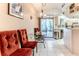 Bright breakfast nook with glass table and red chairs next to a sliding glass door at 5286 Hamlet Cir, Spring Hill, FL 34606