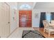 A spacious foyer with a beautiful front door and tile and wood flooring at 5286 Hamlet Cir, Spring Hill, FL 34606
