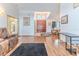 Inviting foyer featuring a grand wooden door and elegant chandelier at 5286 Hamlet Cir, Spring Hill, FL 34606