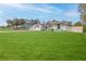 A single-Gathering home has a three-car garage and a massive front yard on a sunny day at 5286 Hamlet Cir, Spring Hill, FL 34606