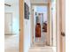 Hallway with doors leading to the living room and bedroom featuring laminate wood flooring at 5286 Hamlet Cir, Spring Hill, FL 34606