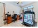 Bright home office with desk, treadmill, and access to the pool area through sliding glass doors at 5286 Hamlet Cir, Spring Hill, FL 34606