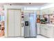 Efficient kitchen space with stainless steel refrigerator and convenient pantry access at 5286 Hamlet Cir, Spring Hill, FL 34606