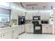 Functional kitchen featuring a stainless steel sink and built-in appliances at 5286 Hamlet Cir, Spring Hill, FL 34606