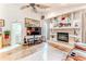 Bright living room with fireplace, mounted TV, and open access to other rooms at 5286 Hamlet Cir, Spring Hill, FL 34606