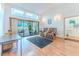A cozy living room has hardwood floors, a large sliding glass door, and plenty of natural light at 5286 Hamlet Cir, Spring Hill, FL 34606