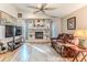 Cozy living room with fireplace, built-in shelves, and comfortable leather seating at 5286 Hamlet Cir, Spring Hill, FL 34606