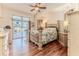 Spacious main bedroom featuring a decorative ceiling fan and sliding glass door to the pool at 5286 Hamlet Cir, Spring Hill, FL 34606