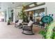Relaxing covered patio featuring comfortable rocking chairs and view of the pool area at 5286 Hamlet Cir, Spring Hill, FL 34606