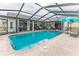 Large screened-in pool with jacuzzi, ample lounging space and convenient backyard access at 5286 Hamlet Cir, Spring Hill, FL 34606