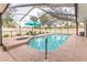 A screened-in pool features a hot tub and patio furniture for ultimate relaxation at 5286 Hamlet Cir, Spring Hill, FL 34606