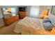 Comfortable bedroom with a queen-size bed and wood dresser at 5434 Chad Pl # 20, New Port Richey, FL 34652