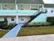 Light teal condo building with stairs and landscaped walkway at 5434 Chad Pl # 20, New Port Richey, FL 34652