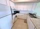 Bright and spacious kitchen with white cabinets and granite countertops at 5434 Chad Pl # 20, New Port Richey, FL 34652