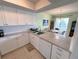 Modern kitchen with white cabinets and granite countertops at 5434 Chad Pl # 20, New Port Richey, FL 34652