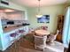 Kitchen with white cabinets, granite counters and breakfast bar at 5434 Chad Pl # 20, New Port Richey, FL 34652