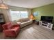 Living room with light colored sofa and wood-look floors at 5434 Chad Pl # 20, New Port Richey, FL 34652