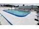 Inviting community swimming pool with surrounding lounge chairs at 5434 Chad Pl # 20, New Port Richey, FL 34652