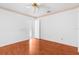 Bedroom with wood flooring, ceiling fan, and an open door at 555 Cressida Cir, Spring Hill, FL 34609