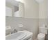 Clean bathroom with neutral tile, a toilet, sink, and shower/tub at 6033 Wilds Dr # B07, New Port Richey, FL 34653