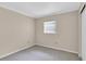 Well-lit bedroom featuring neutral walls and carpet at 6033 Wilds Dr # B07, New Port Richey, FL 34653