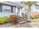 Front entry with stairs, landscaping, and a palm tree at 6033 Wilds Dr # B07, New Port Richey, FL 34653