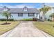 Light blue house exterior with a concrete driveway at 6033 Wilds Dr # B07, New Port Richey, FL 34653