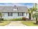 Charming light blue house with palm trees and manicured lawn at 6033 Wilds Dr # B07, New Port Richey, FL 34653