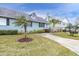 Front exterior of light teal house with palm trees and walkway at 6033 Wilds Dr # B07, New Port Richey, FL 34653