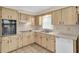 Bright kitchen featuring wood cabinets, built-in appliances, and tile floor at 6033 Wilds Dr # B07, New Port Richey, FL 34653