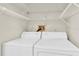 Laundry closet with white washer and dryer and wire shelving at 6033 Wilds Dr # B07, New Port Richey, FL 34653