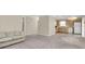Open living and kitchen area with neutral walls and carpeting at 6033 Wilds Dr # B07, New Port Richey, FL 34653