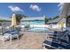 Community swimming pool with lounge chairs and tables at 6033 Wilds Dr # B07, New Port Richey, FL 34653