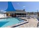 Community pool with a blue shade sail at 6033 Wilds Dr # B07, New Port Richey, FL 34653
