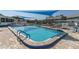 Refreshing community pool with patio furniture under shade sails at 6033 Wilds Dr # B07, New Port Richey, FL 34653