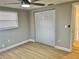 Bedroom with light gray walls, wood-look flooring, and double door closet at 7207 Nova Scotia Dr, Port Richey, FL 34668