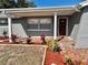 Newly renovated house with covered porch and walkway,landscaped with red mulch at 7207 Nova Scotia Dr, Port Richey, FL 34668