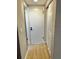 Clean hallway with light walls and wood-look floors at 7207 Nova Scotia Dr, Port Richey, FL 34668