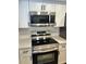 Modern kitchen with stainless steel appliances and white cabinets at 7207 Nova Scotia Dr, Port Richey, FL 34668