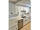 Modern kitchen with white cabinets, quartz countertops, and stainless steel appliances at 7207 Nova Scotia Dr, Port Richey, FL 34668