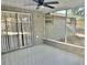 Cozy screened porch with tiled floor and ceiling fan at 7207 Nova Scotia Dr, Port Richey, FL 34668
