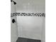 Stylish shower with patterned tile and hexagon floor at 7207 Nova Scotia Dr, Port Richey, FL 34668
