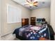 Bedroom with a bed, dresser, and home office setup at 7448 Mengi Cir, New Port Richey, FL 34653