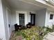 Inviting front porch with seating area and tile flooring at 7727 Danube Dr # 7727, Hudson, FL 34667