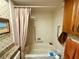 Bathroom with shower/tub combo, granite vanity, and linen closet at 8111 Merrimac Dr, Port Richey, FL 34668