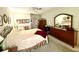 Main bedroom with dresser and large bed at 8111 Merrimac Dr, Port Richey, FL 34668
