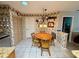 Charming kitchen dining area, featuring a round table and wooden chairs at 8111 Merrimac Dr, Port Richey, FL 34668