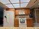 Kitchen boasts ample wood cabinets, granite counters, and a skylight at 8111 Merrimac Dr, Port Richey, FL 34668
