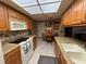 Kitchen with granite countertops, wood cabinets, and eat-in area at 8111 Merrimac Dr, Port Richey, FL 34668